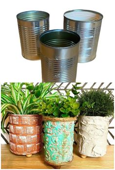 three tin can planters sitting on top of a wooden table next to potted plants