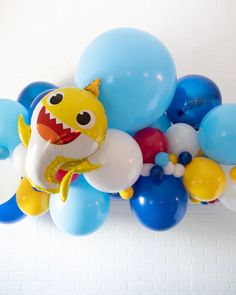 a bunch of balloons that are in the shape of a shark with teeth on it