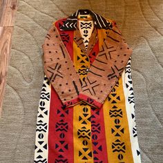 Multi Earth Tone Colors With Brown Mud Cloth Sleeves Trimmed In Red Cotton African Fabric. Black/Brown Mud Cloth Collar. Buttons Up Front. New In Good Condition. Smoke/Pet Free Home. Size L, Armpit-To-Armpit: 25"; Length Of Coat: 45.5"; Sleeve Length: 22 3/4". #3 Adinkra Cloth, Mudcloth Fabric, Earth Tone Colors, Trench Coat Men, Fabric Black, African Fabric, Mud Cloth, Earth Tones, African Print