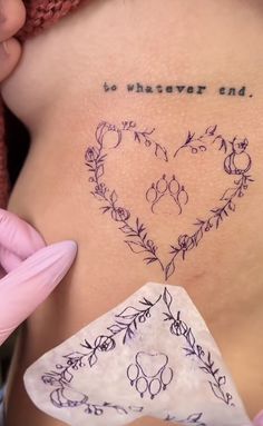 a woman's stomach with writing on it that says to whatever end, and an arrow in the shape of a heart