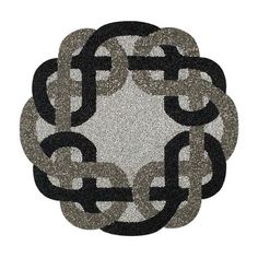 a black and white circular rug with chains on the center, surrounded by smaller circles