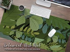 a computer mouse and keyboard sitting on top of a green leafy desk mat with the words botanical design