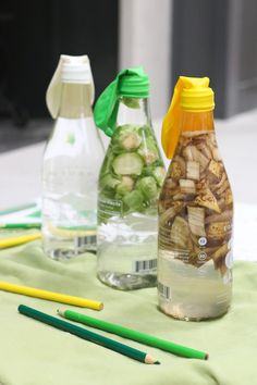 three bottles filled with water sitting on top of a table