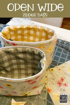 an open wide zipper bag sitting on top of a table next to a sewing machine