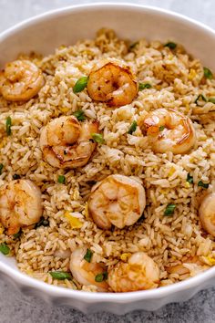 a white bowl filled with rice and shrimp