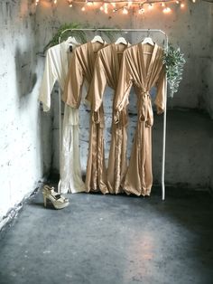 some clothes hanging up on a rack in a room with string lights and fairy lights