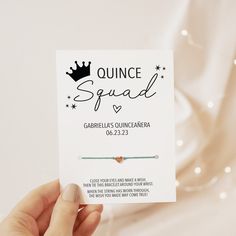 a person holding up a card with the words quince squad on it and a crown