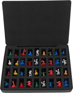 an open case filled with chess pieces on top of a white surface and black background