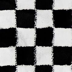 a black and white checkered rug is shown in close up, it looks like the fabric has been cut into squares