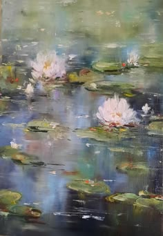 two white water lilies floating on top of a pond