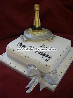 a birthday cake with a bottle of champagne on top