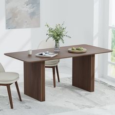 a dining table with two chairs and a bowl of fruit on the plate next to it