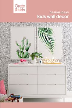 a white dresser sitting next to a green plant