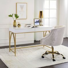 a white desk with gold legs and a chair in front of it on a rug