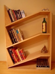 a book shelf with books and a bottle on top