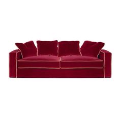 a red couch with two pillows on it and one pillow in the middle of the back