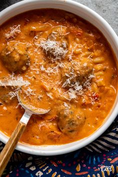 a white bowl filled with meatballs and sauce