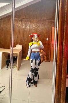 a woman in a cowgirl costume is walking through the room with her legs crossed