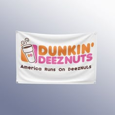 the dunkin'deeznuts flag is hanging from a pole in front of a gray background