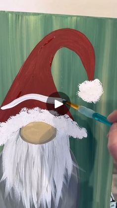 someone is painting a santa clause hat on a canvas