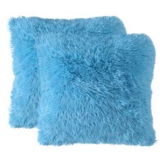 two blue fluffy pillows sitting next to each other