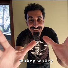 a man making a funny face while holding his hands in front of him with the caption wacky wakey