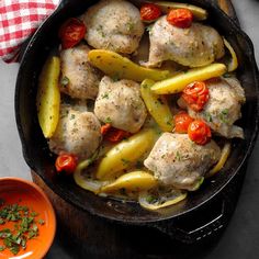 a skillet filled with chicken and peppers