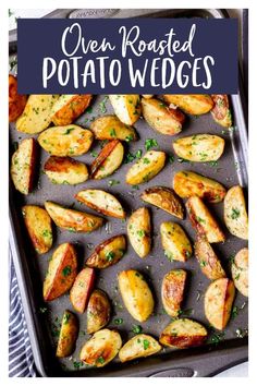 baked potatoes in a baking pan with parsley on the side, ready to be cooked