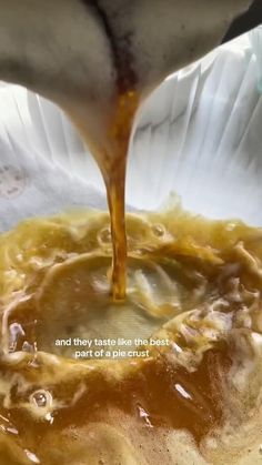 a bowl filled with soup and sauce being poured over the top to make it look like something out of a movie