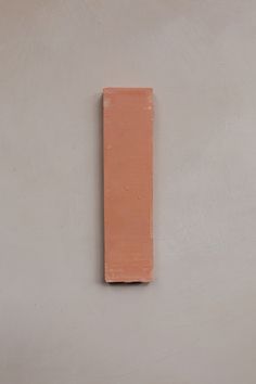 a piece of clay sitting on top of a white wall