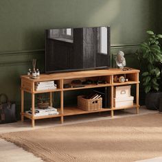 a living room scene with focus on the television and shelf holding various items in baskets