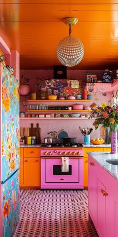 an orange and pink kitchen with lots of colorful decor on the walls, floors and ceiling