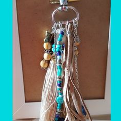 a key chain with beads and tassels hanging from it