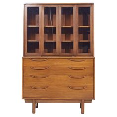 a wooden cabinet with glass doors on the front and drawers in the back, against a white background