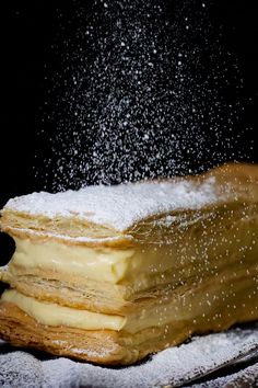 a stack of pancakes covered in powdered sugar