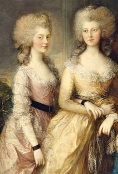 two women in formal dress standing next to each other