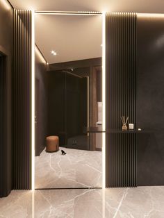 the interior of a bathroom with marble floors and walls, lighted by recessed lighting