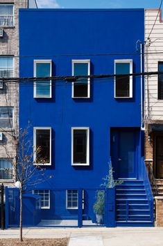 a blue building with many windows and stairs