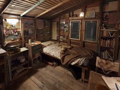 a bedroom with wooden walls and flooring has an old fashioned bed in the corner