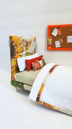 a bed that has been made with sunflowers on it and is next to a bulletin board