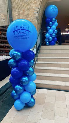 blue balloons are attached to the steps in front of a building