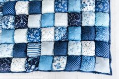 a blue and white patchwork quilt on a table