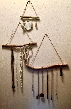 a wall hanging made out of wood and various jewelry pieces on it's sides