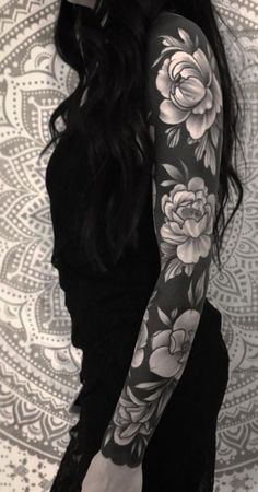 a woman with black and white tattoos on her arm