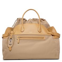 Beige nylon bag from The Row. The Margaux inside out bag is made of technical nylon canvas and leather with external pockets and gusseted side panels. It has a capacious silhouette complete with double top handles. Measurements: L43 x H30 x W25 cmMade in Italy Ss22 Runway, Beige Shoulder Bag, Bags 2022, Nylon Shoulder Bag, Minimalist Women, Drawstring Top, Celebrity Kids, Nylon Bag, Side Panels