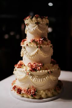 a three tiered wedding cake with flowers on it