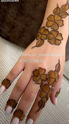 a woman's hand with flowers on it