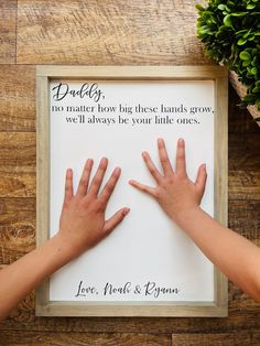 two hands reaching for each other in front of a sign that reads daddy, no matter how big these hands grow, we'll always be your little ones