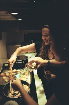 two women are preparing food in a kitchen