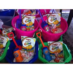 several plastic buckets filled with toys and candy